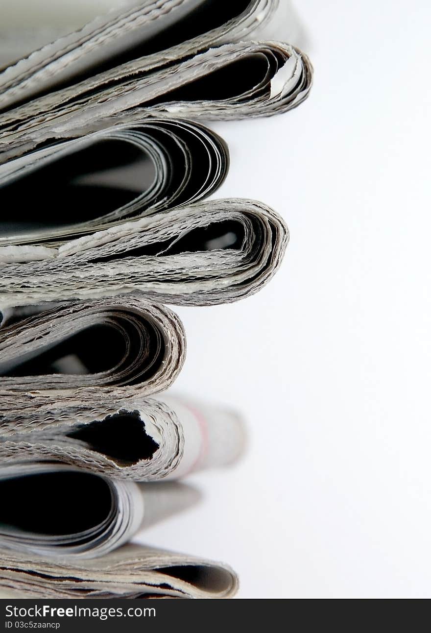 Stack of daily newspapers in white background