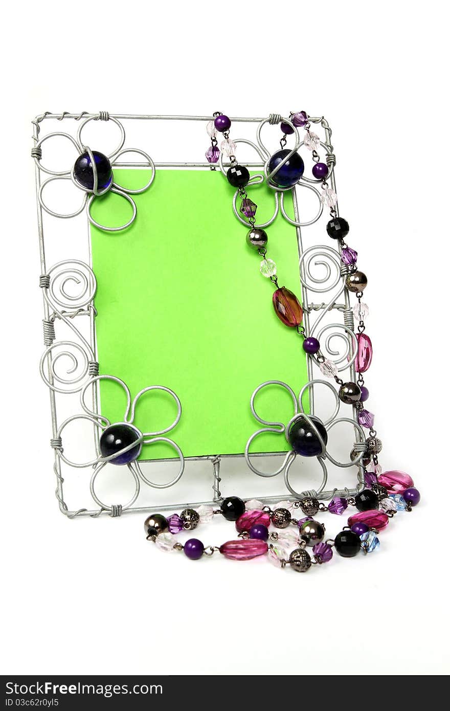 Wire picture frame with purple beads and green key center. Wire picture frame with purple beads and green key center