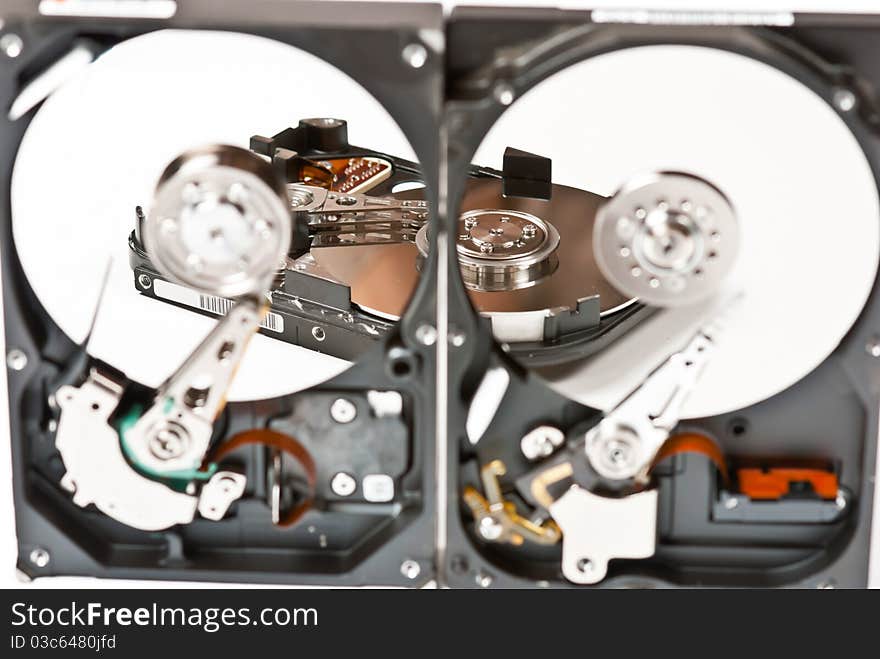 Opened hard disks on white background. Studio shot