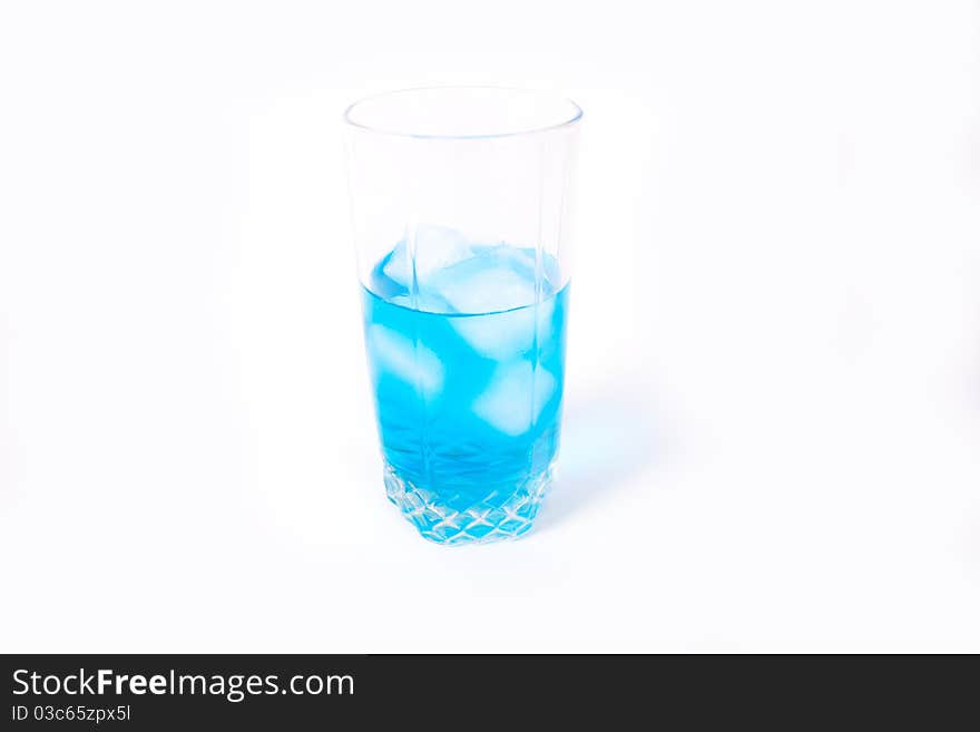 Transparent glass with a blue drink and ice. Transparent glass with a blue drink and ice