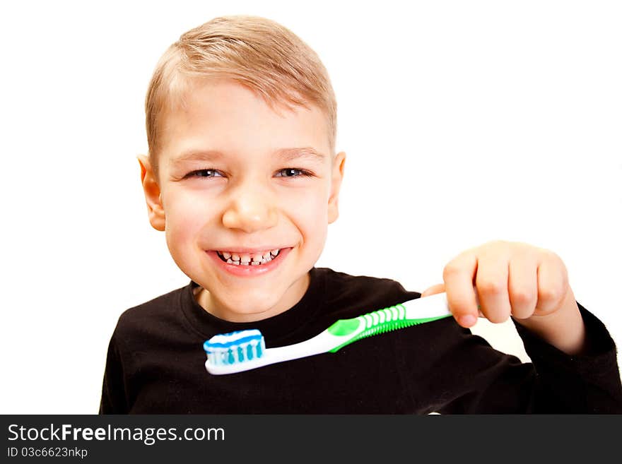 The boy brushes teeth a brush on a white background