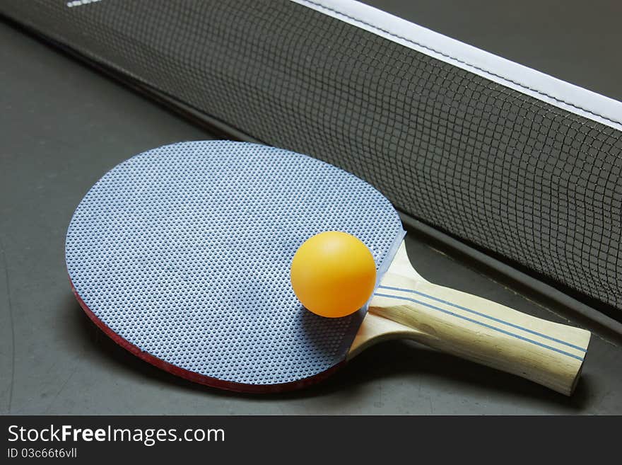 Ping pong paddle, ball and table all ready for a game