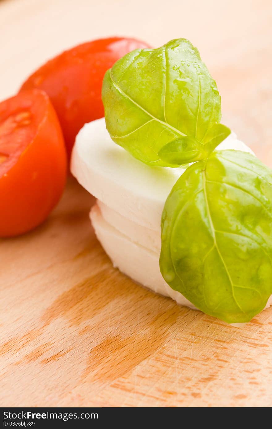 Tomatoe And Mozzarella On Cutting Board