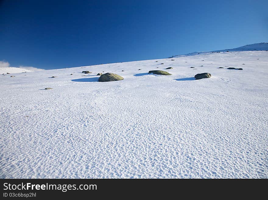 Three rocks on snow