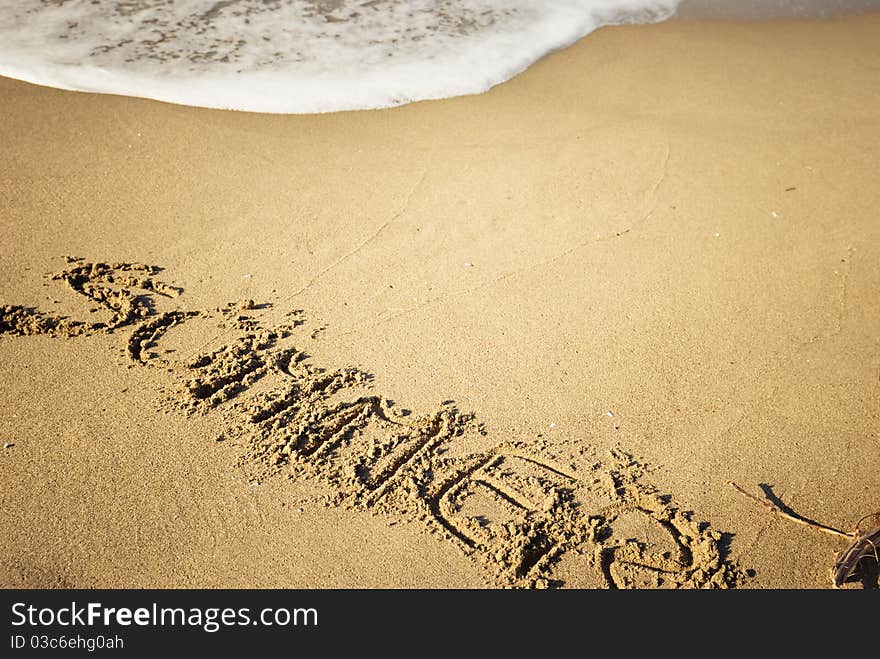 Word summer written on sand