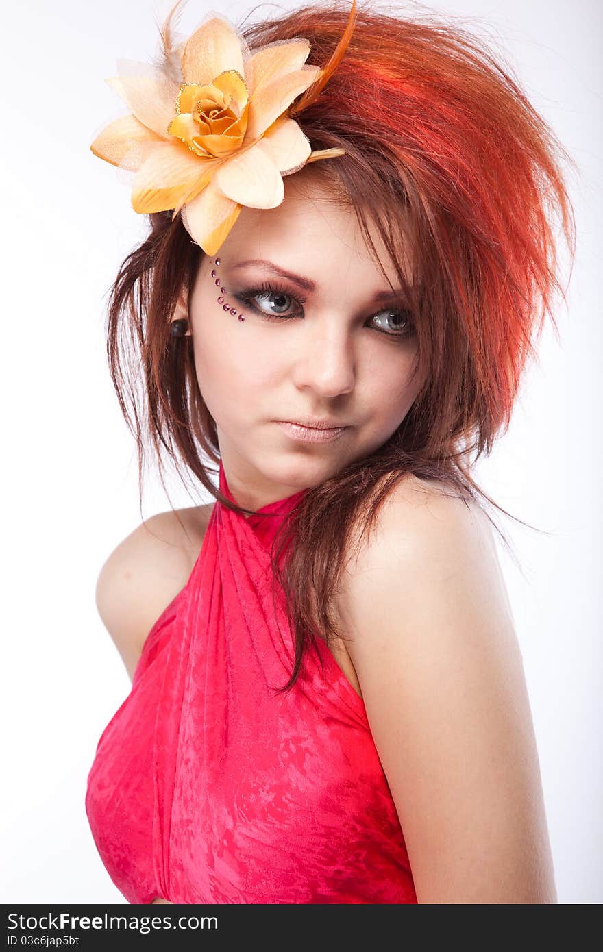 Portrait of beautiful woman with spring flower in hair on white