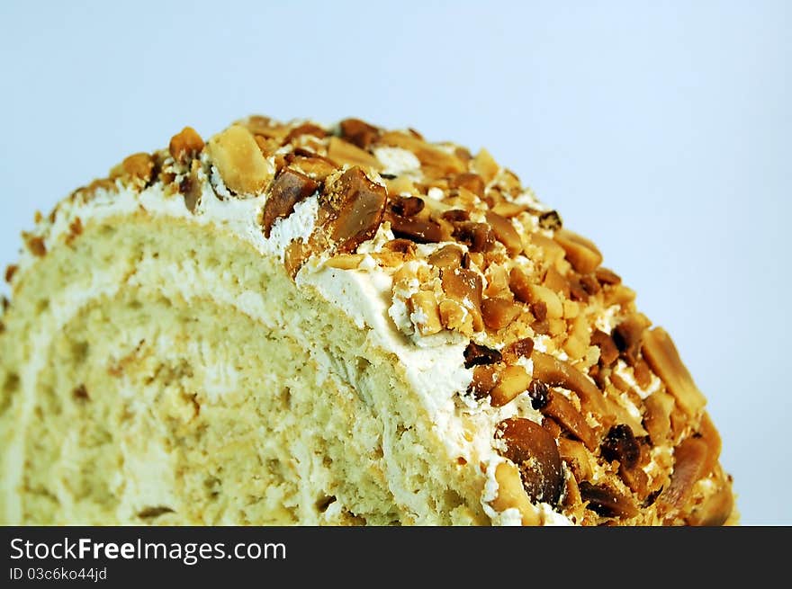 Slice roll with cream and nuts on top. Slice roll with cream and nuts on top