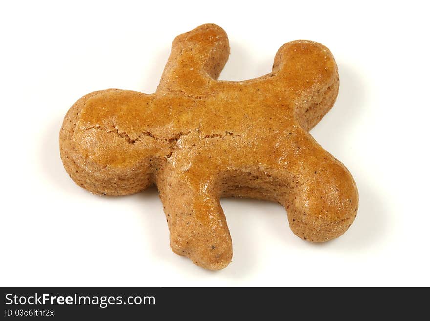 Gingerbread man lying over white