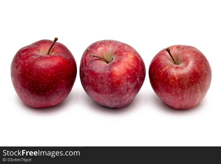 Three red apples over white background