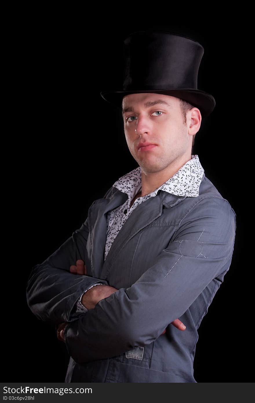 Emotional portrait of the serious man in a black top-hat