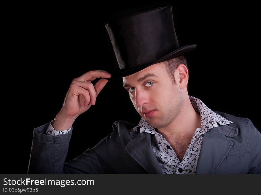 Emotional portrait of the serious man in a black top-hat