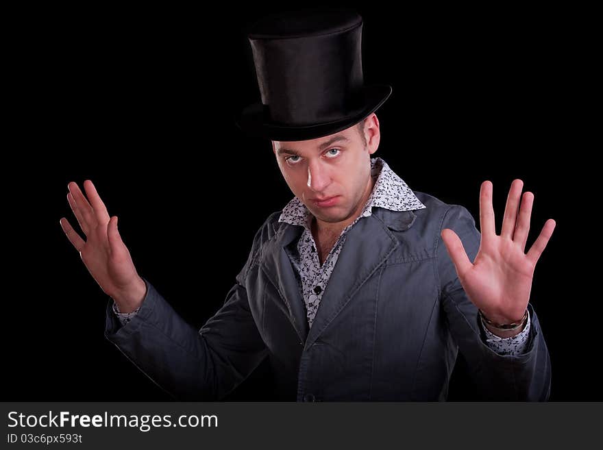 Emotional portrait of the serious man in a black top-hat