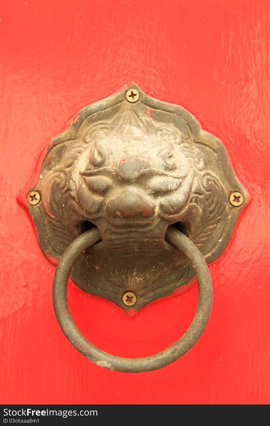 Oriental door knob on red background