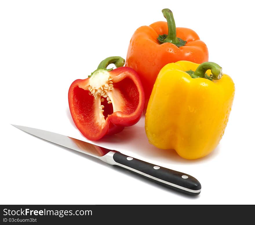 Bell peppers and knife isolated on white.