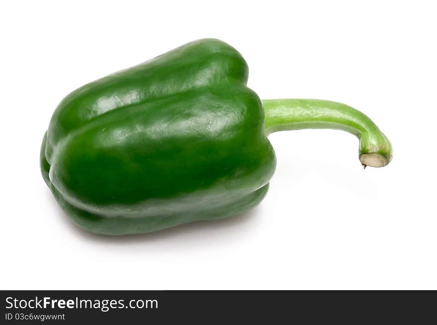 Single green paprika over a white background