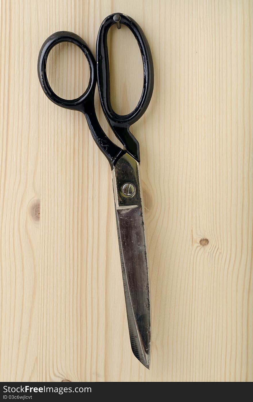 Tailor scissors hanging on the nail