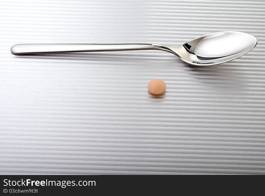 Spoon with a pill near