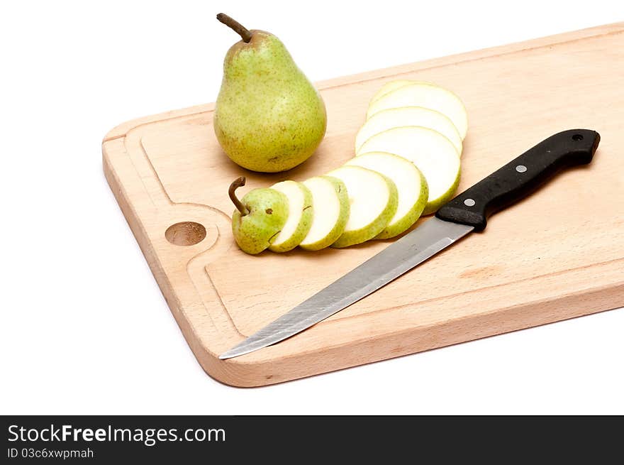 Pear and slices with knife on chopping board over white background