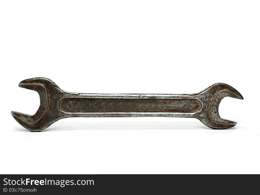 Old wrench on a white background, close-up.