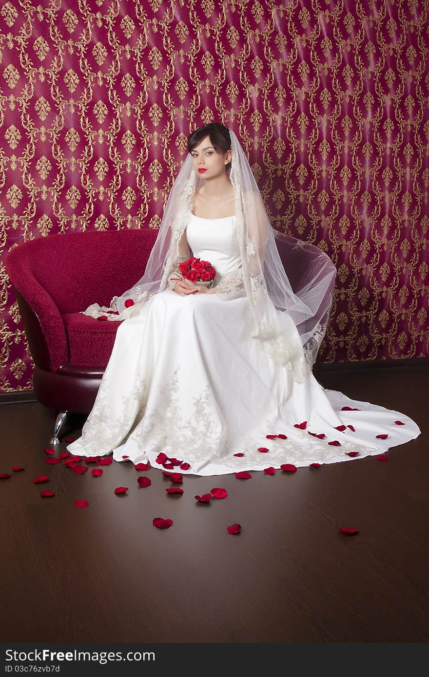 The women in the dress of the bride sitting on the couch. The women in the dress of the bride sitting on the couch