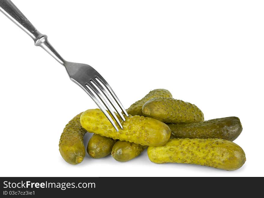 Marinated cornichones and fork