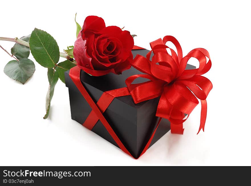 Gift box with a rose isolated on white background