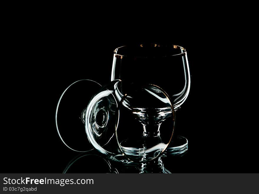 Two empty wine glasses. Black background. Studio shot. Two empty wine glasses. Black background. Studio shot.