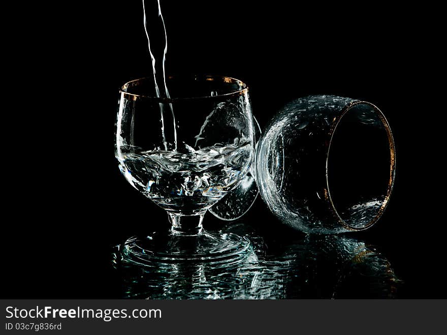 Two wine glasses with drops of water on it. Black background. Studio shot. Two wine glasses with drops of water on it. Black background. Studio shot.