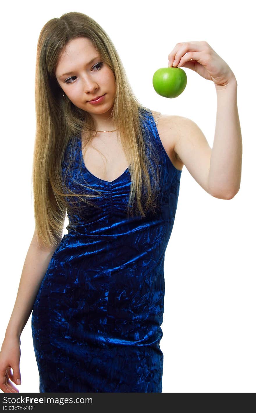 Girl in blue dress with a green apple