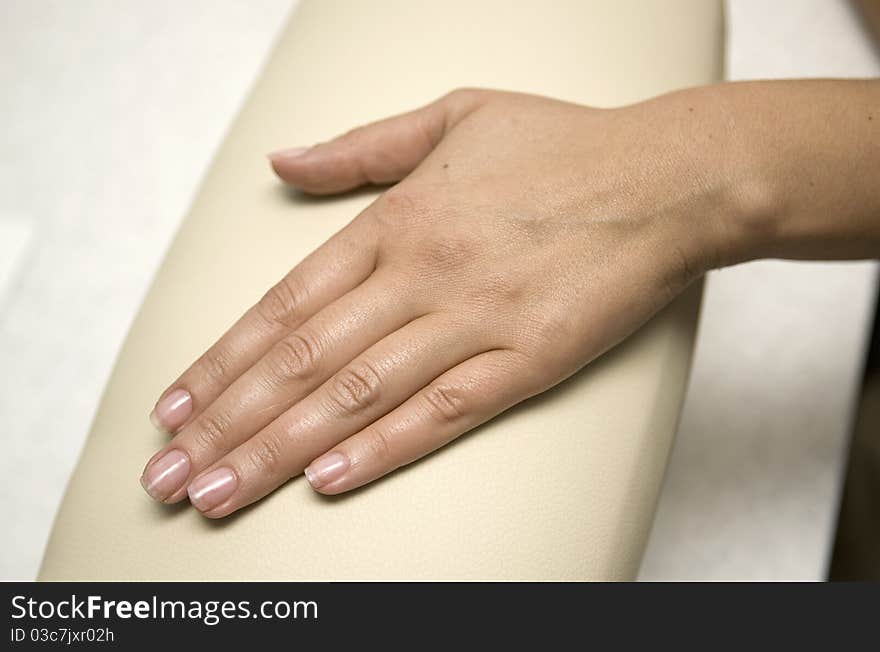 Hand with natural manicure in salon