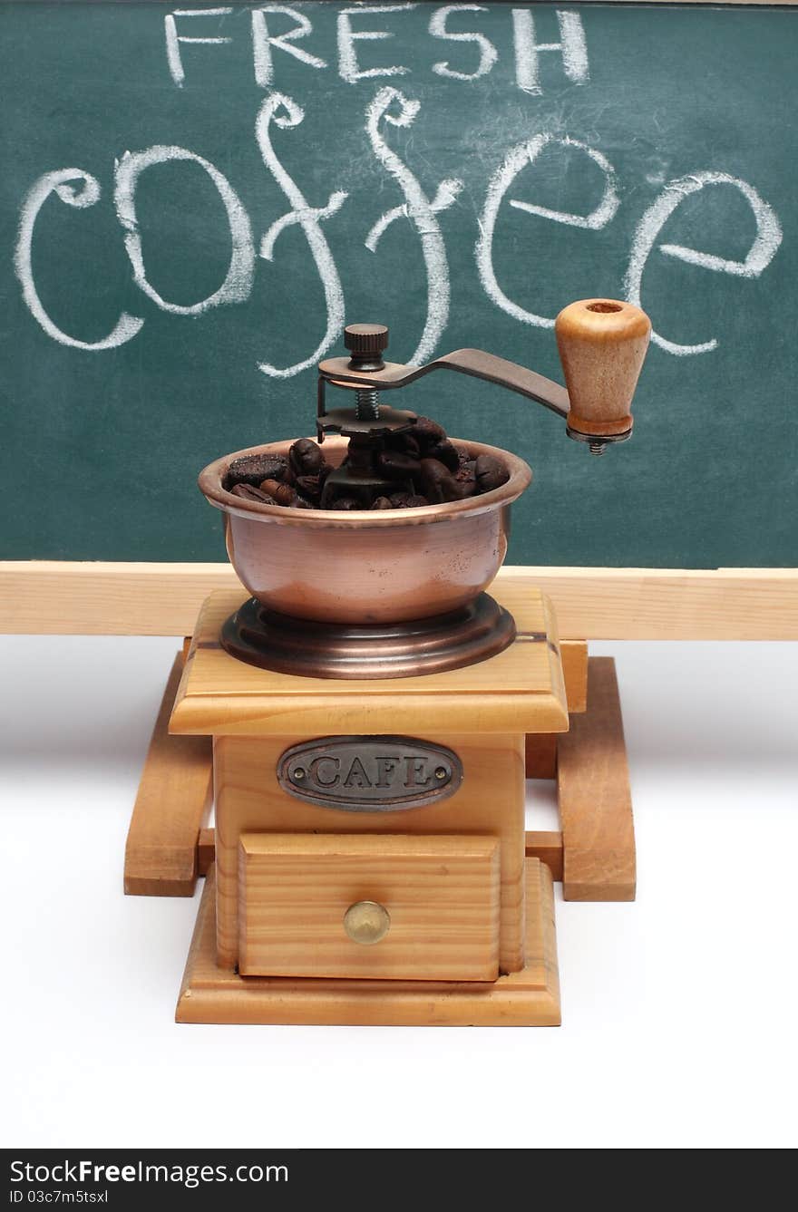 Chalkboard and coffee mill close up