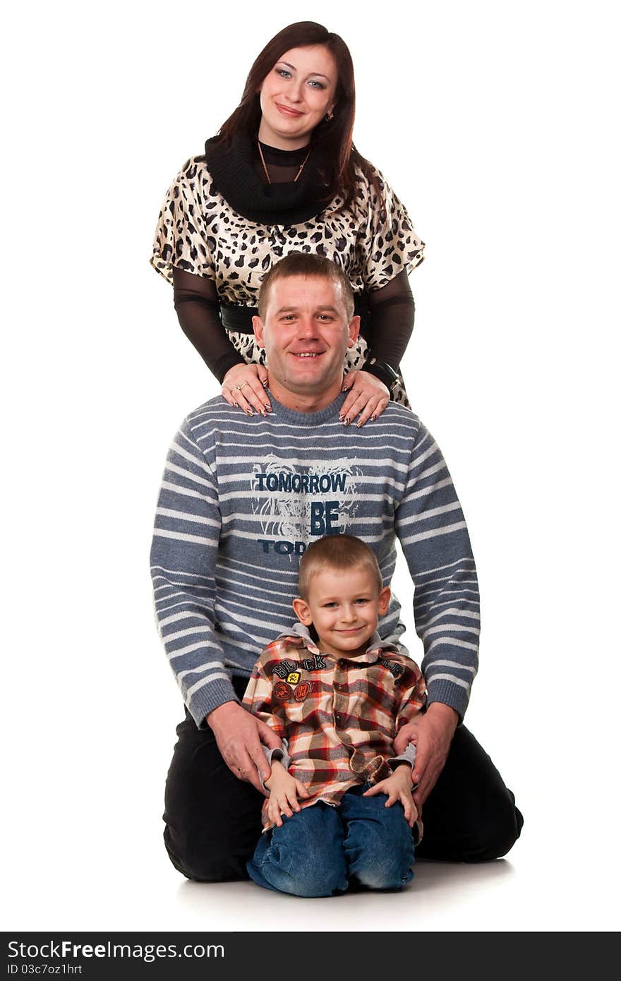 Portrait of a young happy smiling family isolated on white