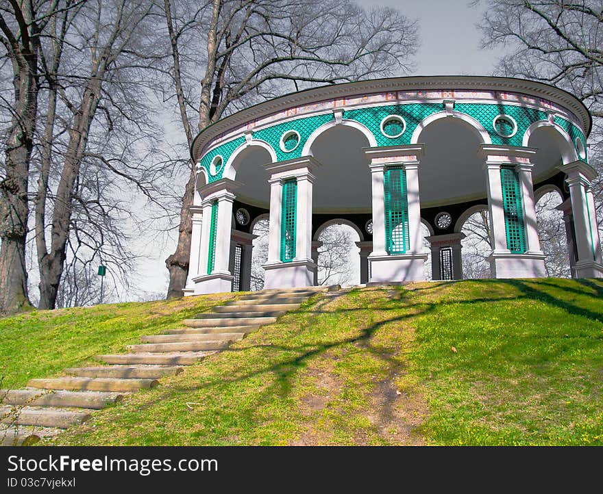 A construction on a green hill with steps to it. A construction on a green hill with steps to it