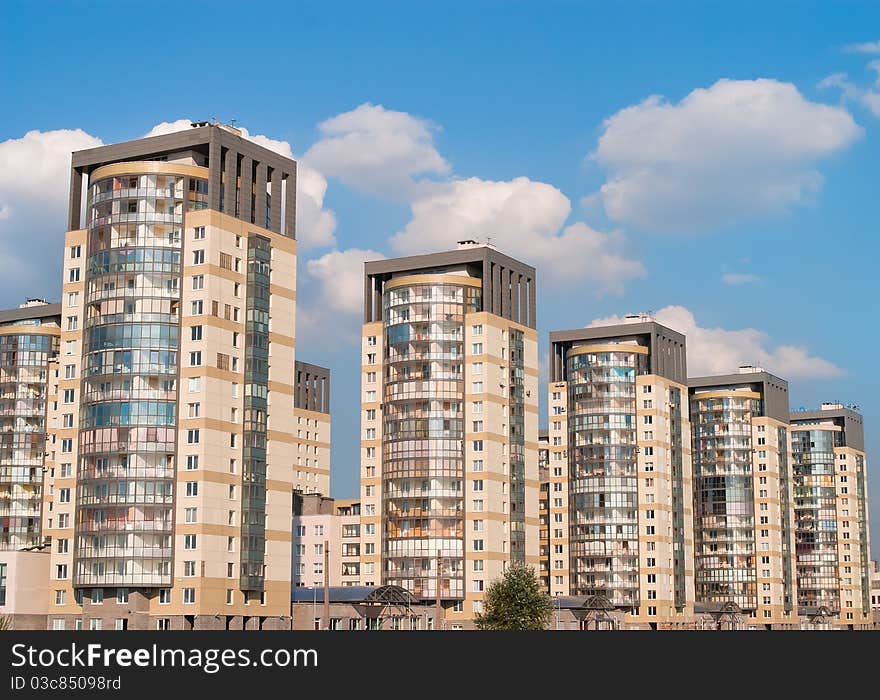 Dwelling houses constructed cascade on the blue sky background