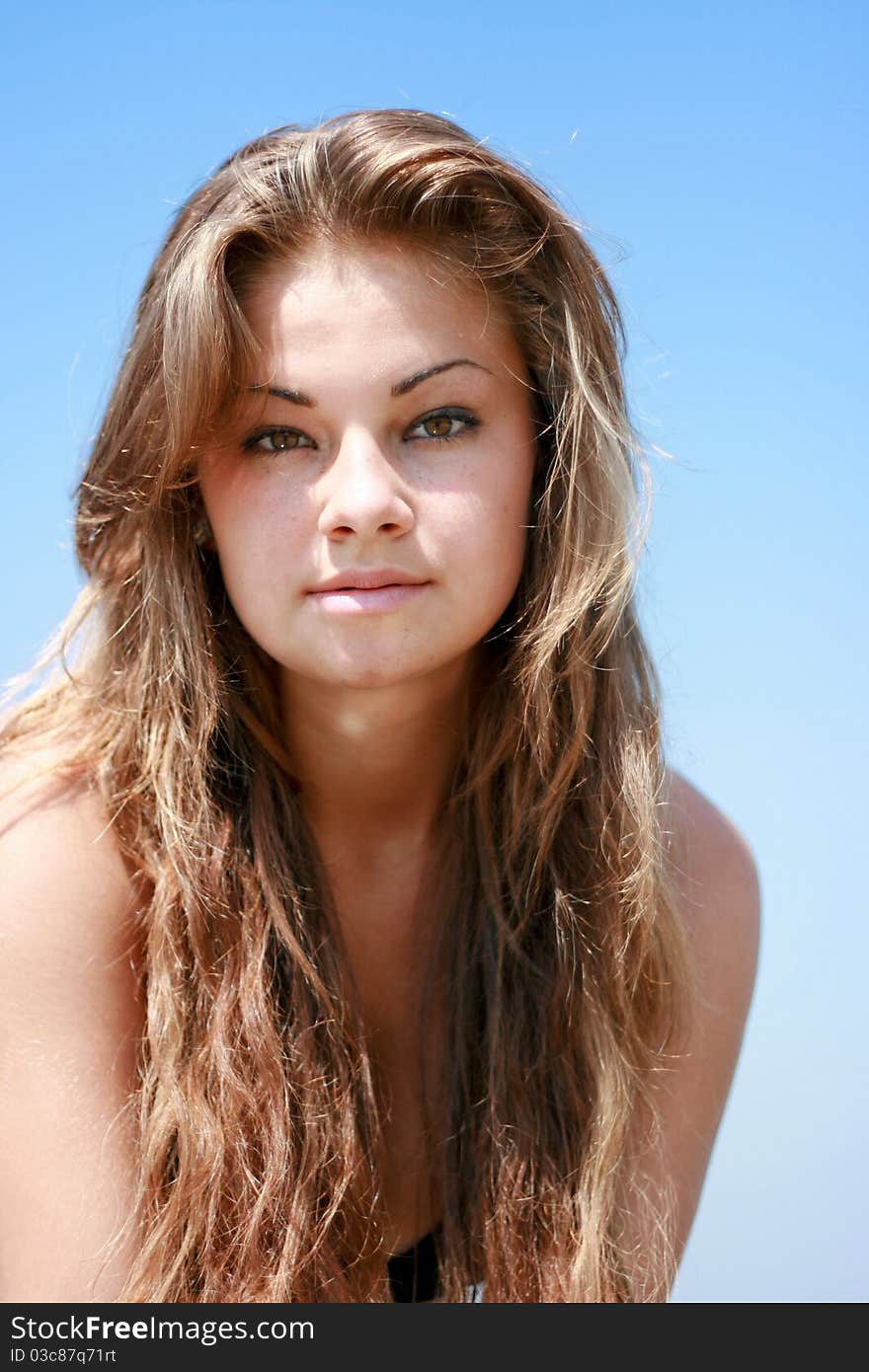 Beautiful young caucasian women portrait against blue sky