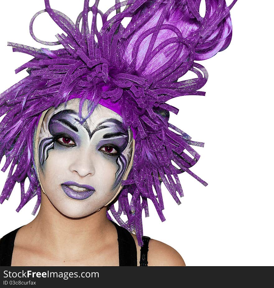 Girl make-up, white background, in a ridiculous wig, looks into the camera. Girl make-up, white background, in a ridiculous wig, looks into the camera.