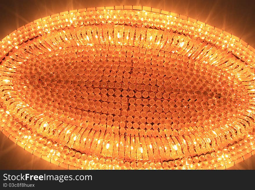 A crystal chandelier at ceiling.Image was taken in a meeting room.