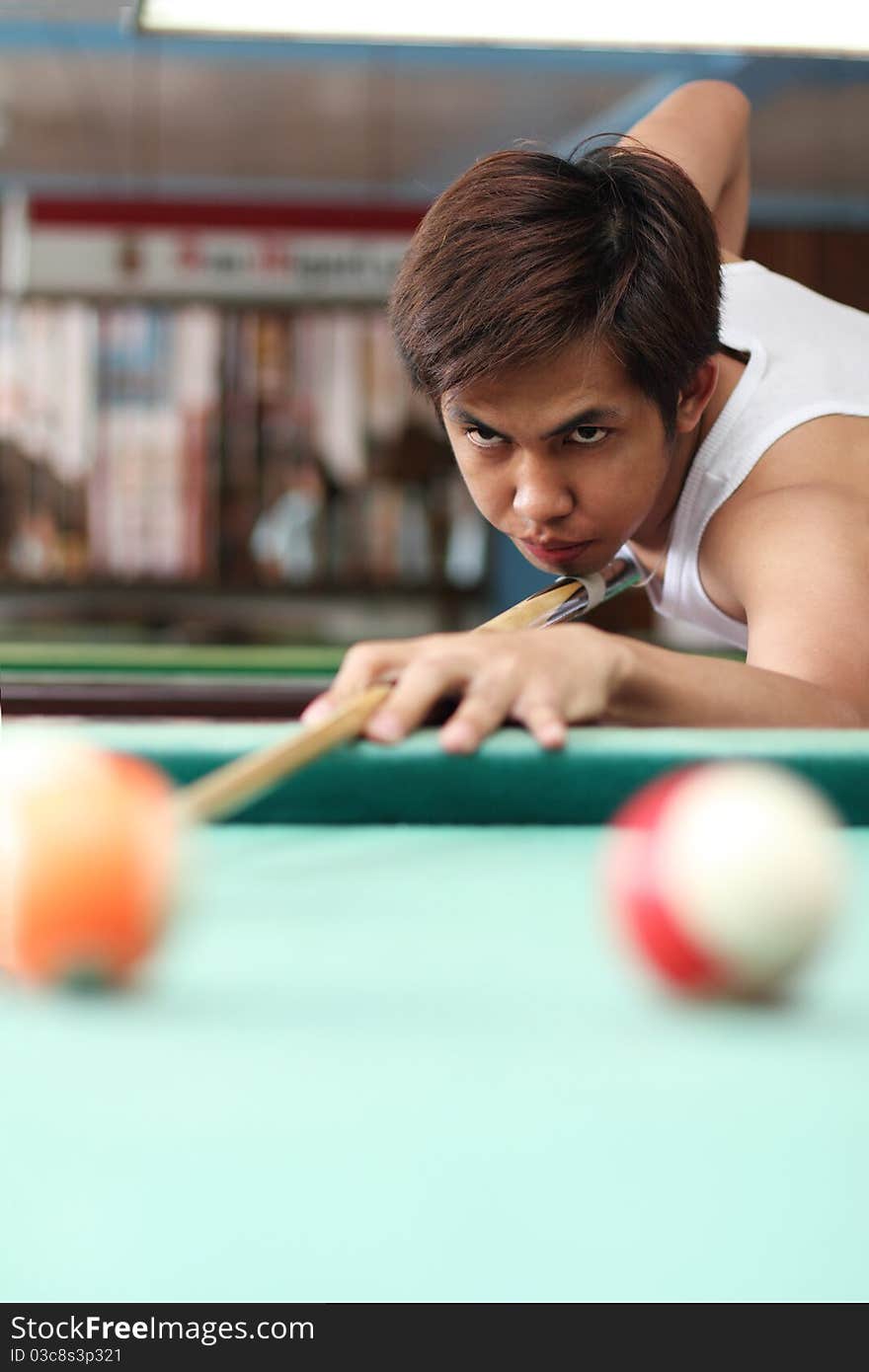 Billiard player in deep concentration