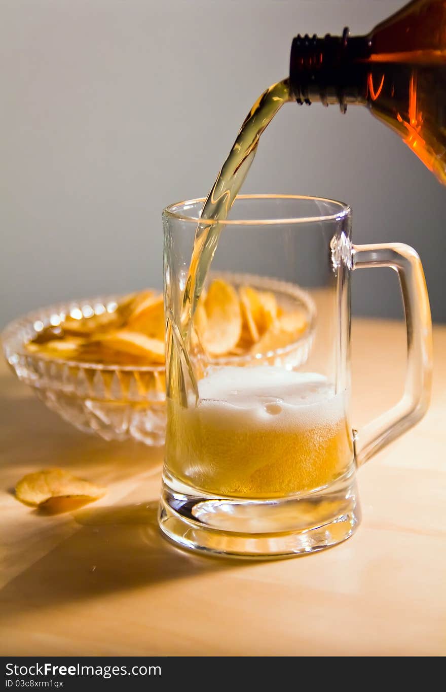 Bubbles in beer mug foam and stream from a bottle. Bubbles in beer mug foam and stream from a bottle