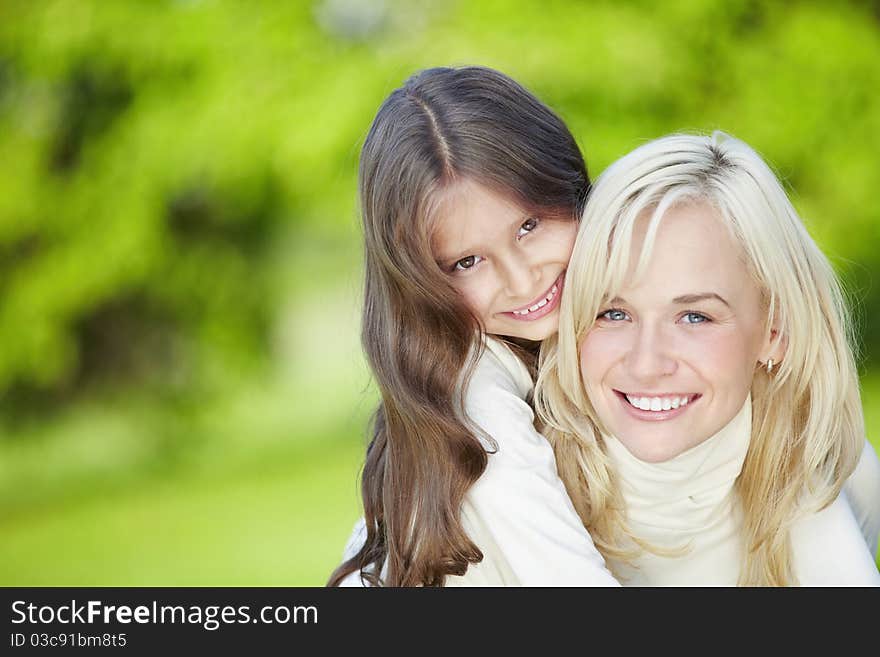 Happy mother and daughter outdoors. Happy mother and daughter outdoors