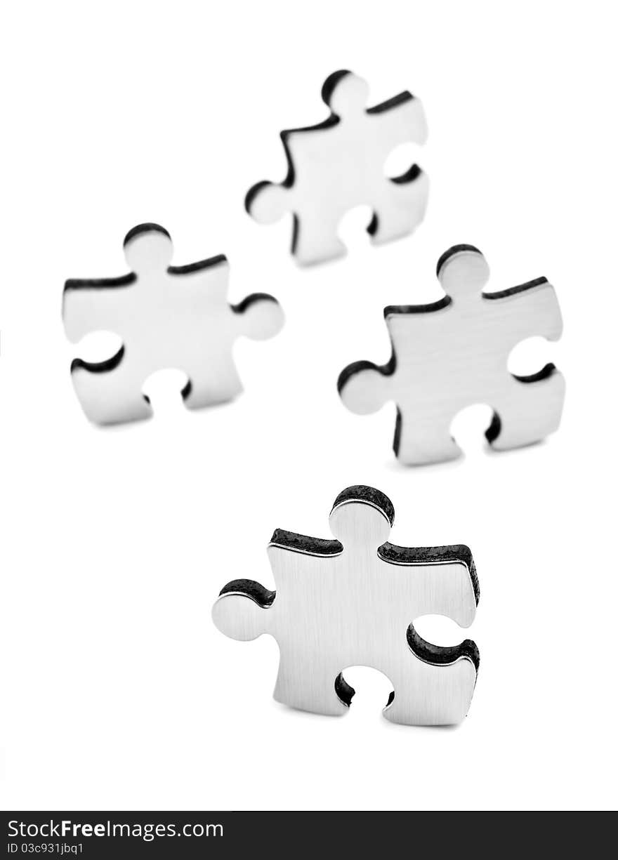 Stainless Steel Puzzles Pieces On White Background