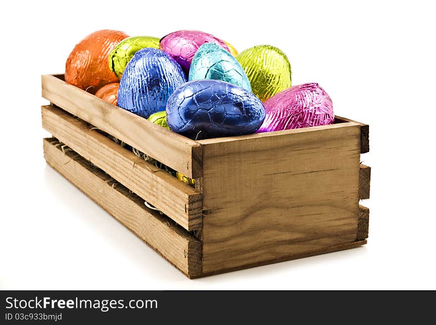 Colorful easter eggs in wooden box on white background. Colorful easter eggs in wooden box on white background