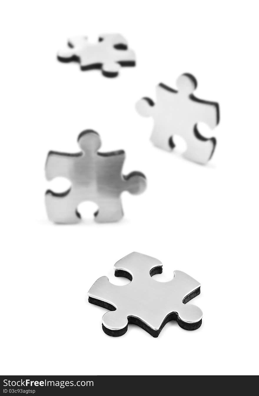 Stainless Steel Puzzles Pieces On White Background