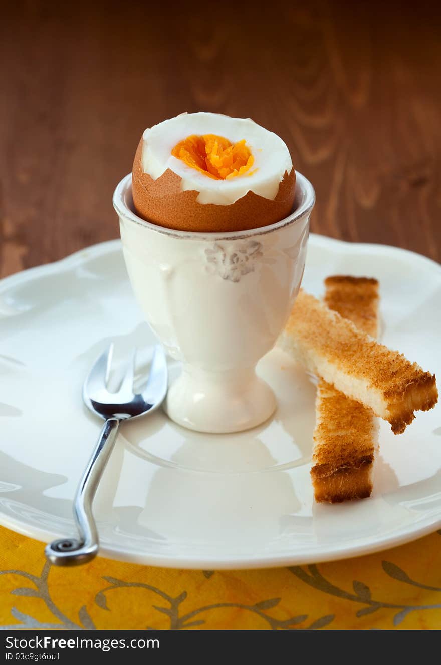 Boiled egg in an eggcup and toast