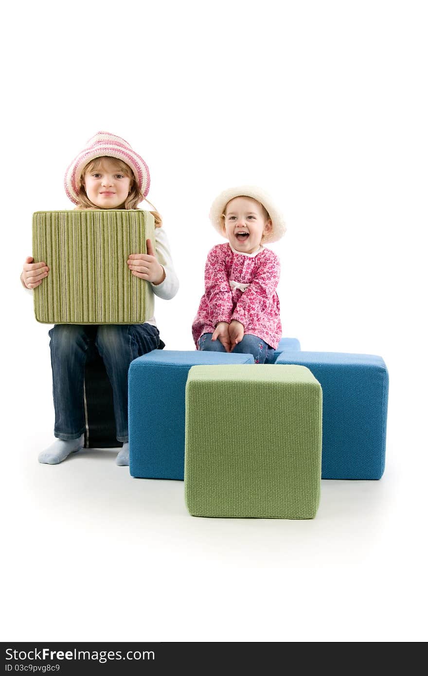 Merry girls with big cube on playing, on white background. Merry girls with big cube on playing, on white background.