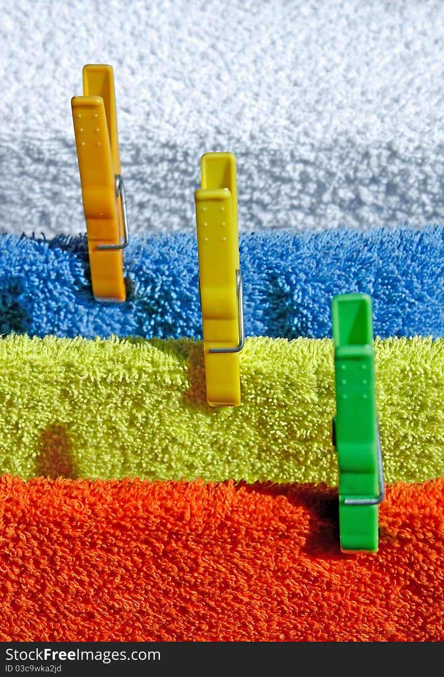 Four cotton colorful towels drying in the sun. Four cotton colorful towels drying in the sun