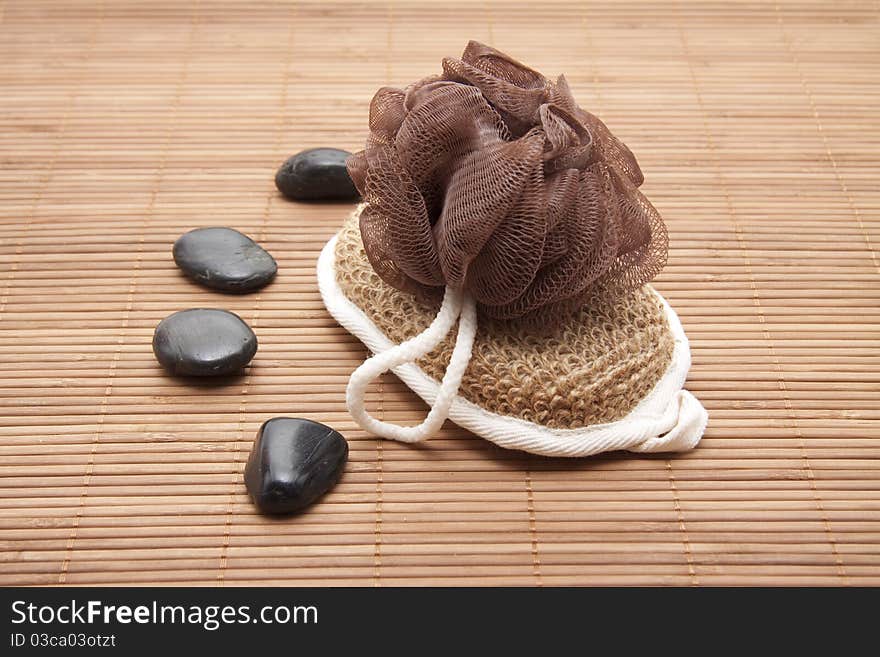 Massage sponge and stones on mat