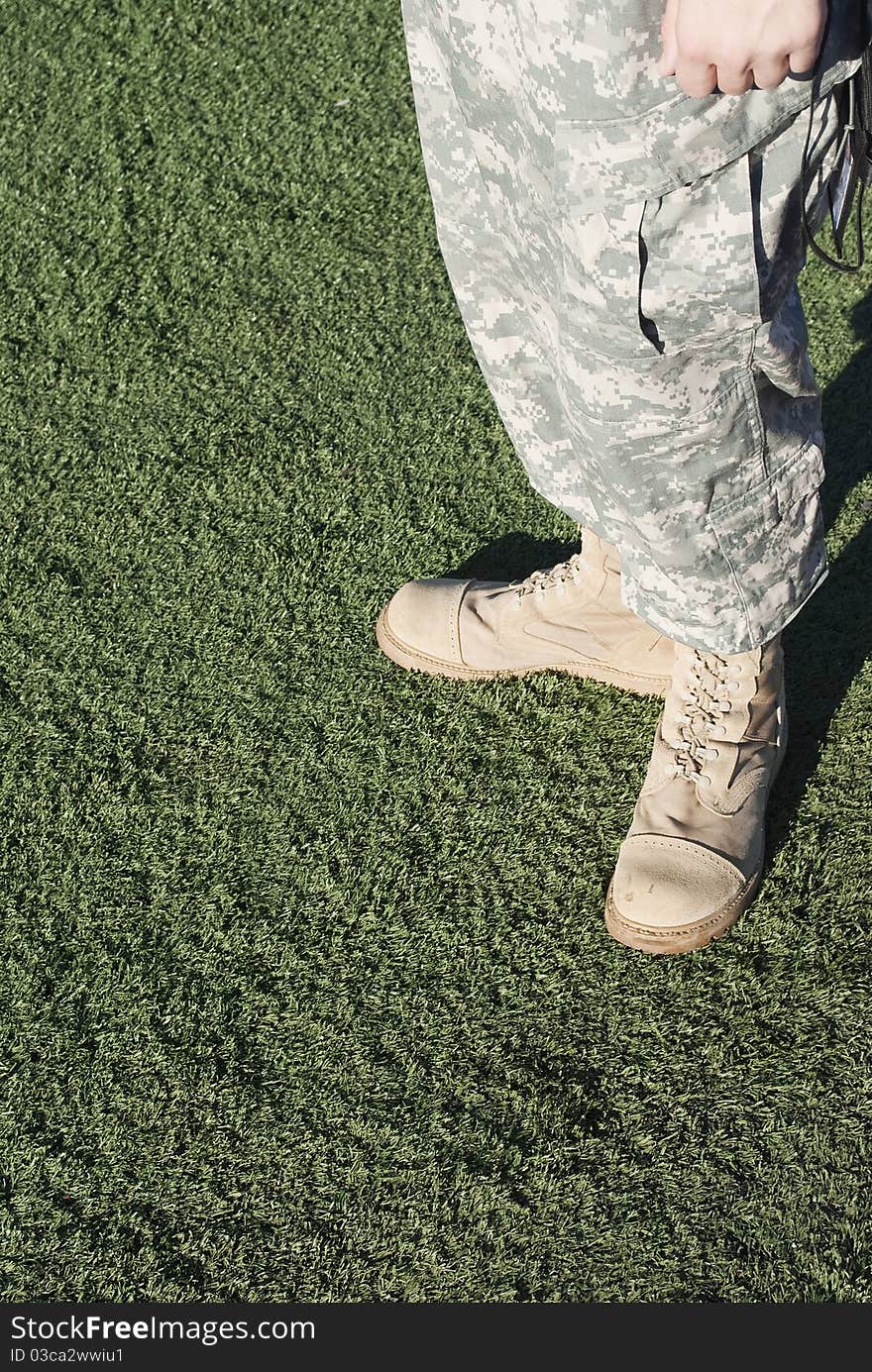 Soldier in camouflage pants and army boots.