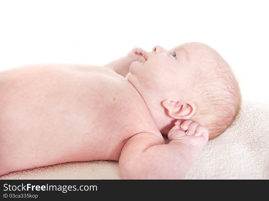 Baby laying down on a white background. Baby laying down on a white background