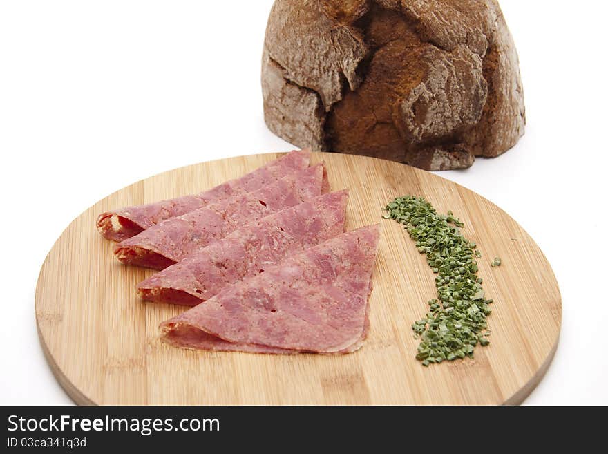 Corned beef with chives and bread onto wood plates. Corned beef with chives and bread onto wood plates